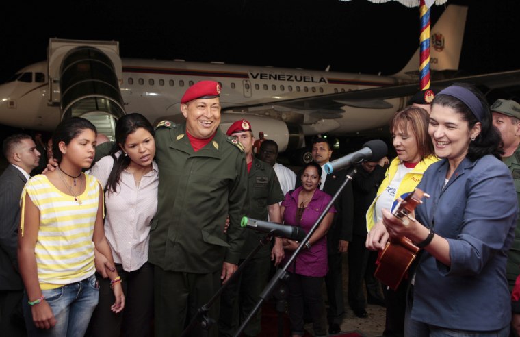 Image: Venezuelan President Hugo Chavez listens to a performance before departing for Cuba at Maiquetia's Airport outside Caracas
